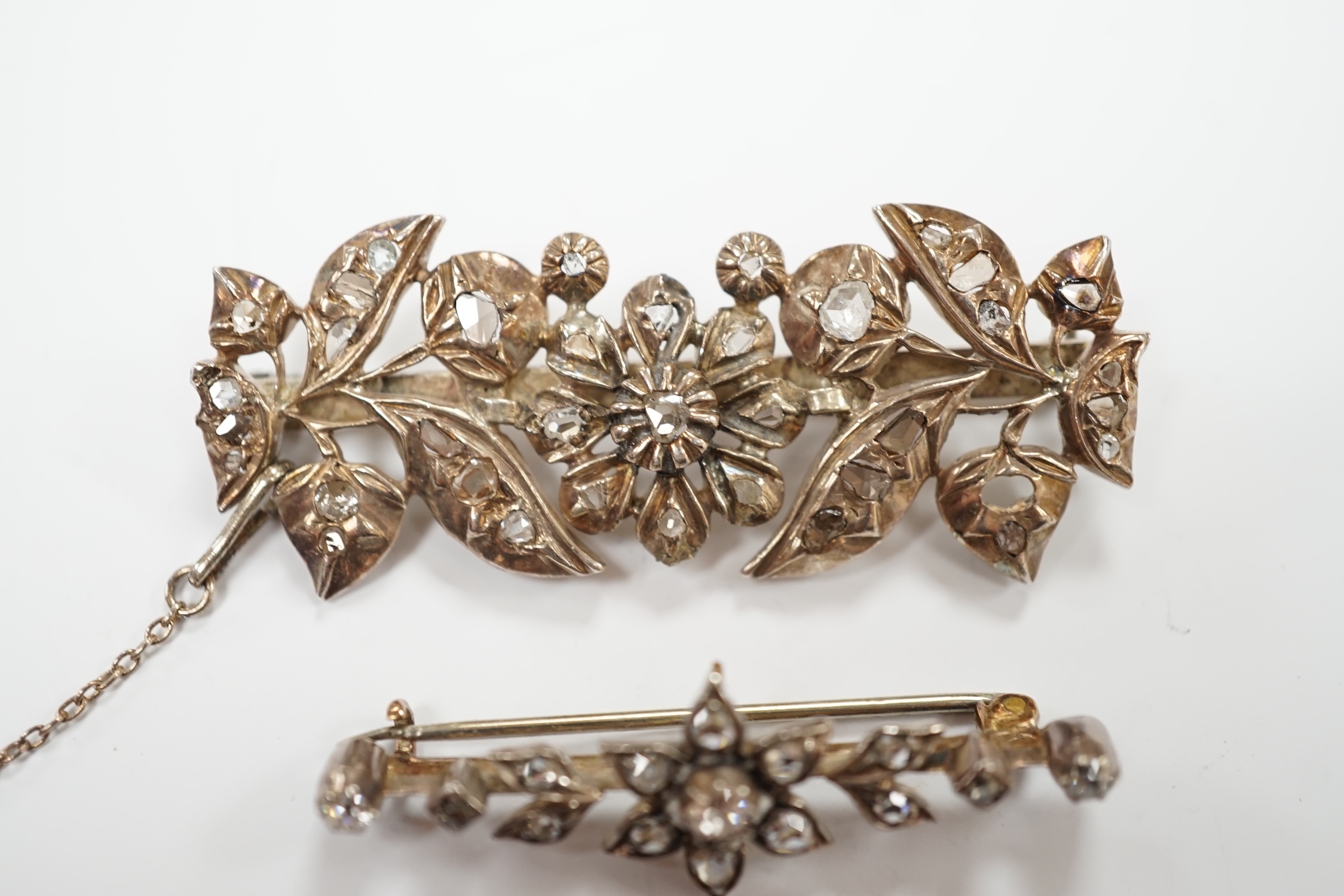 Two early 20th century yellow and white metal, rose cut diamond set foliate brooches, largest 51mm, gross weight 13.9 grams.